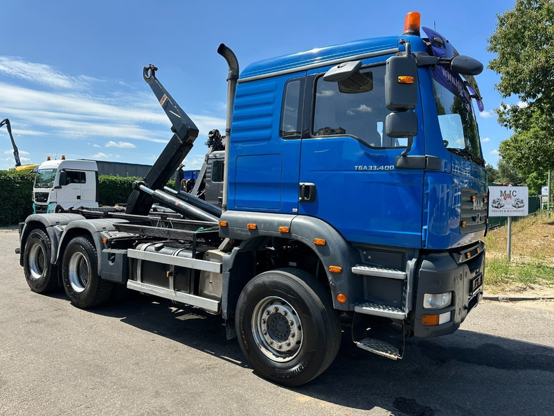 MAN TGA 33.400 6X4 HOOKLIFT AJK NHS20-4930mm - WB 3m60 - MANUAL ZF - STEEL SPRING / BLATT - BIG AXLES / AP ACHSEN - شاحنة ذات خطاف: صورة 1 MAN TGA 33.400 6X4 HOOKLIFT AJK NHS20-4930mm - WB 3m60 - MANUAL ZF - STEEL SPRING / BLATT - BIG AXLES / AP ACHSEN - شاحنة ذات خطاف: صورة 1