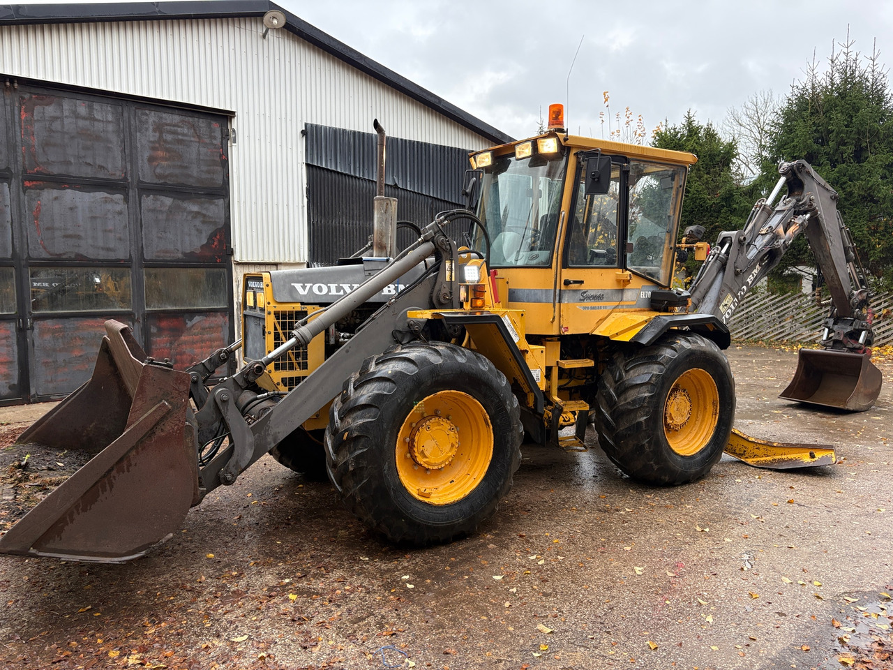 Volvo BM EL70C - جرافة حفار: صورة 1 Volvo BM EL70C - جرافة حفار: صورة 1