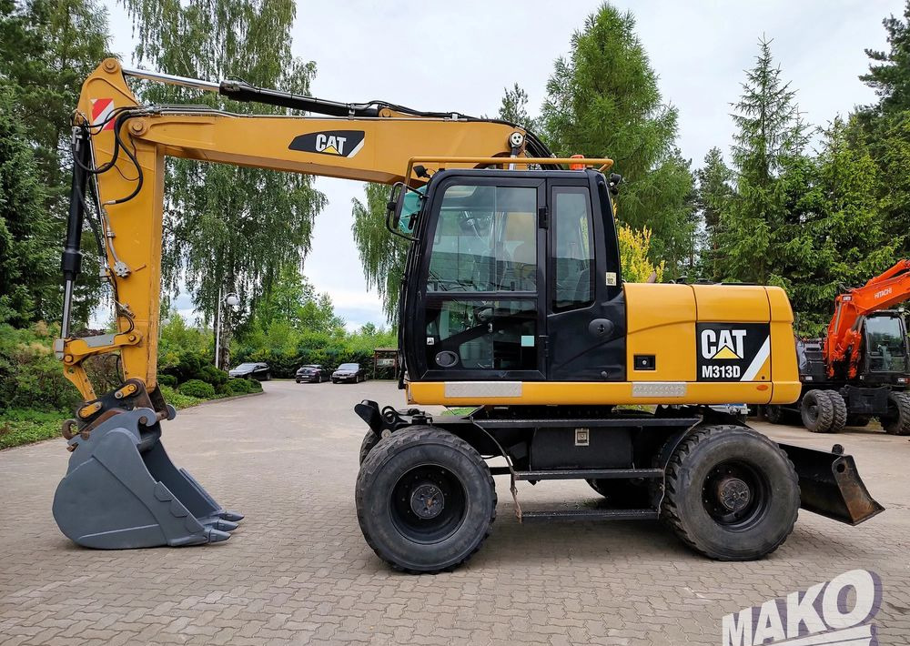 Caterpillar M313D - حفارة دولاب: صورة 1 Caterpillar M313D - حفارة دولاب: صورة 1