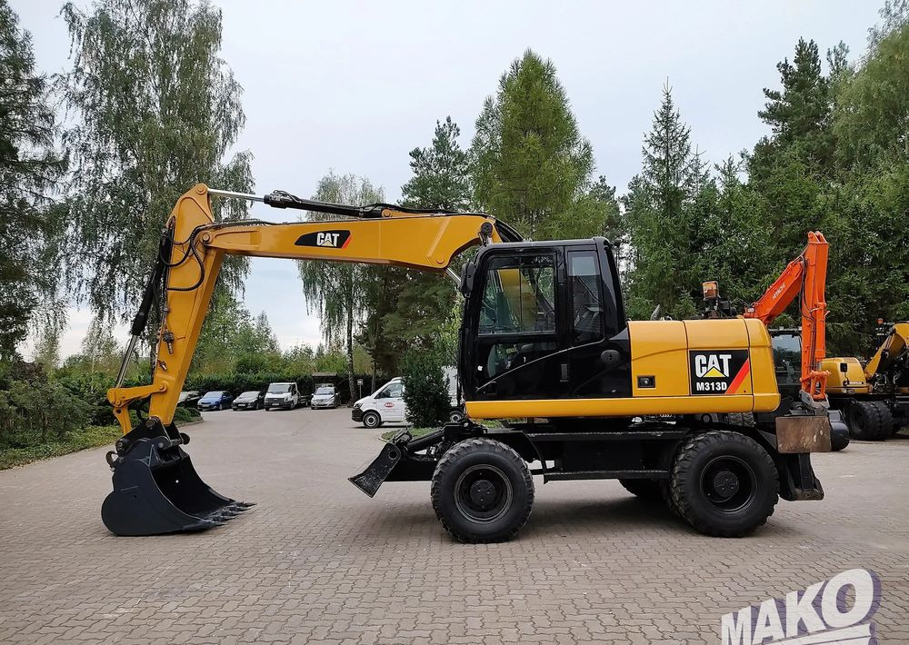 Caterpillar M313D - حفارة دولاب: صورة 1 Caterpillar M313D - حفارة دولاب: صورة 1
