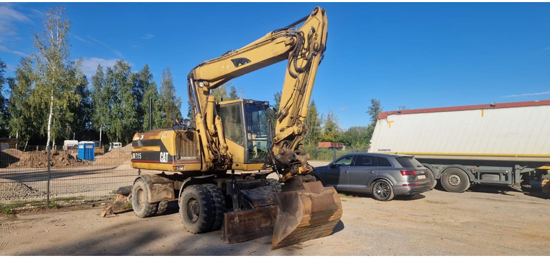 Caterpillar M 315 Rototilt - حفارة دولاب: صورة 1 Caterpillar M 315 Rototilt - حفارة دولاب: صورة 1