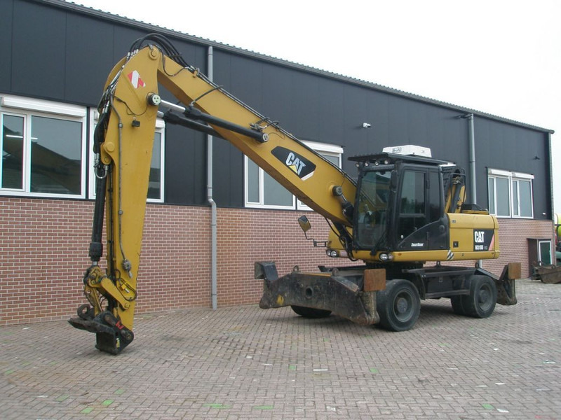 Caterpillar M318D - حفارة دولاب: صورة 1 Caterpillar M318D - حفارة دولاب: صورة 1