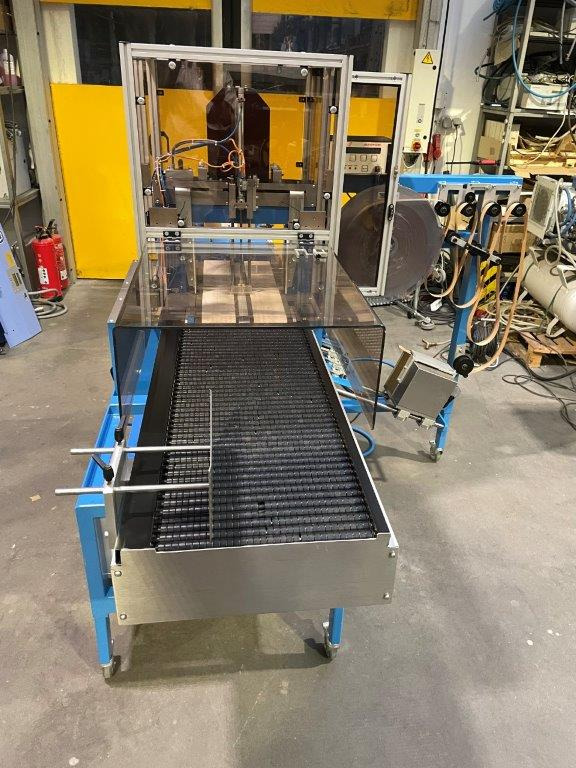 ATS Tanner UltraSonic US 2000-AB transit banding machine with pneumatic product hold-down and infeed roller table - آلة التعبئة والتغليف: صورة 4 ATS Tanner UltraSonic US 2000-AB transit banding machine with pneumatic product hold-down and infeed roller table - آلة التعبئة والتغليف: صورة 4