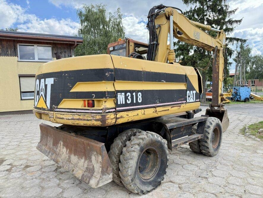 CAT M318 - حفارة دولاب: صورة 1 CAT M318 - حفارة دولاب: صورة 1