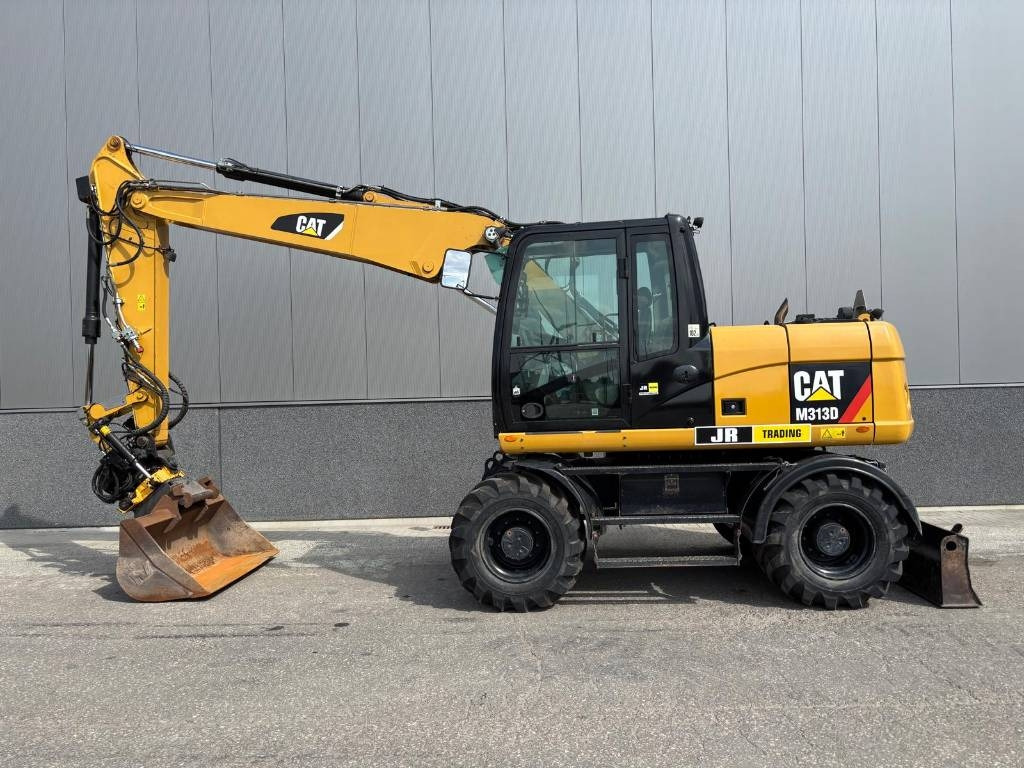 CAT M 313 D - حفارة دولاب: صورة 1 CAT M 313 D - حفارة دولاب: صورة 1