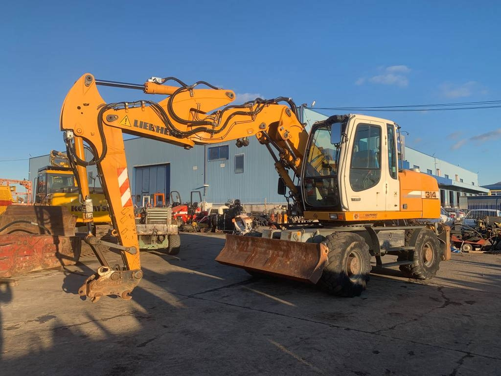 Liebherr A 314 Litronic - حفارة دولاب: صورة 1 Liebherr A 314 Litronic - حفارة دولاب: صورة 1