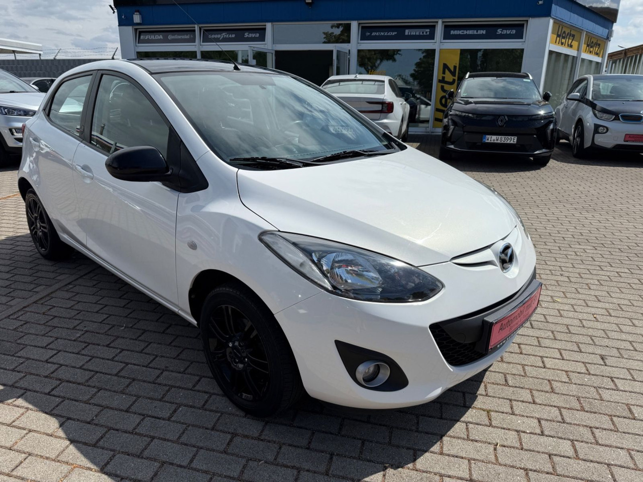 Mazda 2 Lim. 1.3 Origami 5 TÜER KLIMA SHZ TÜV NEU - سيارة: صورة 2 Mazda 2 Lim. 1.3 Origami 5 TÜER KLIMA SHZ TÜV NEU - سيارة: صورة 2