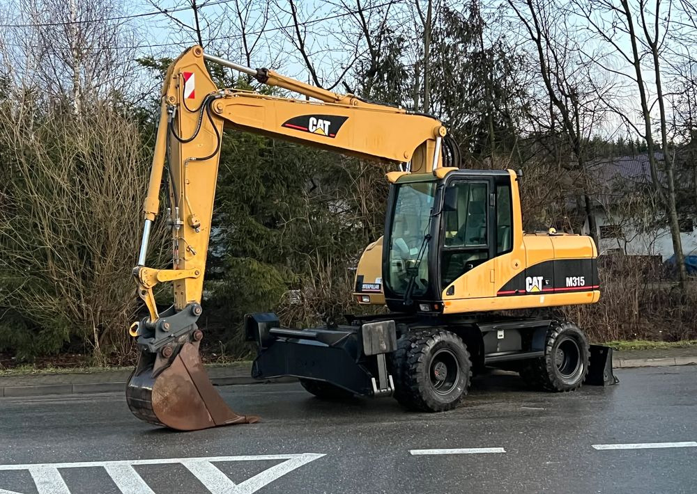 Caterpillar CAT M315C CATERPILLAR SPROWADZONY Bardzo Dobry Stan - حفارة دولاب: صورة 1 Caterpillar CAT M315C CATERPILLAR SPROWADZONY Bardzo Dobry Stan - حفارة دولاب: صورة 1