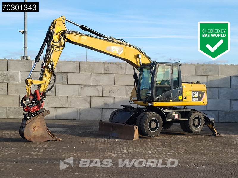 Caterpillar M315 D OUTRIGGERS + BLADE - حفارة دولاب: صورة 1 Caterpillar M315 D OUTRIGGERS + BLADE - حفارة دولاب: صورة 1