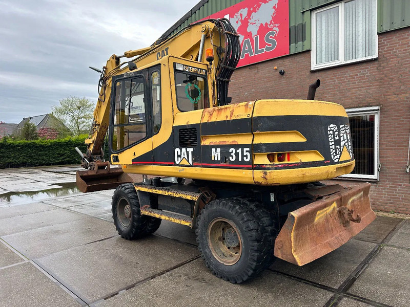 Caterpillar M315 +ROTO CE - حفارة دولاب: صورة 4 Caterpillar M315 +ROTO CE - حفارة دولاب: صورة 4