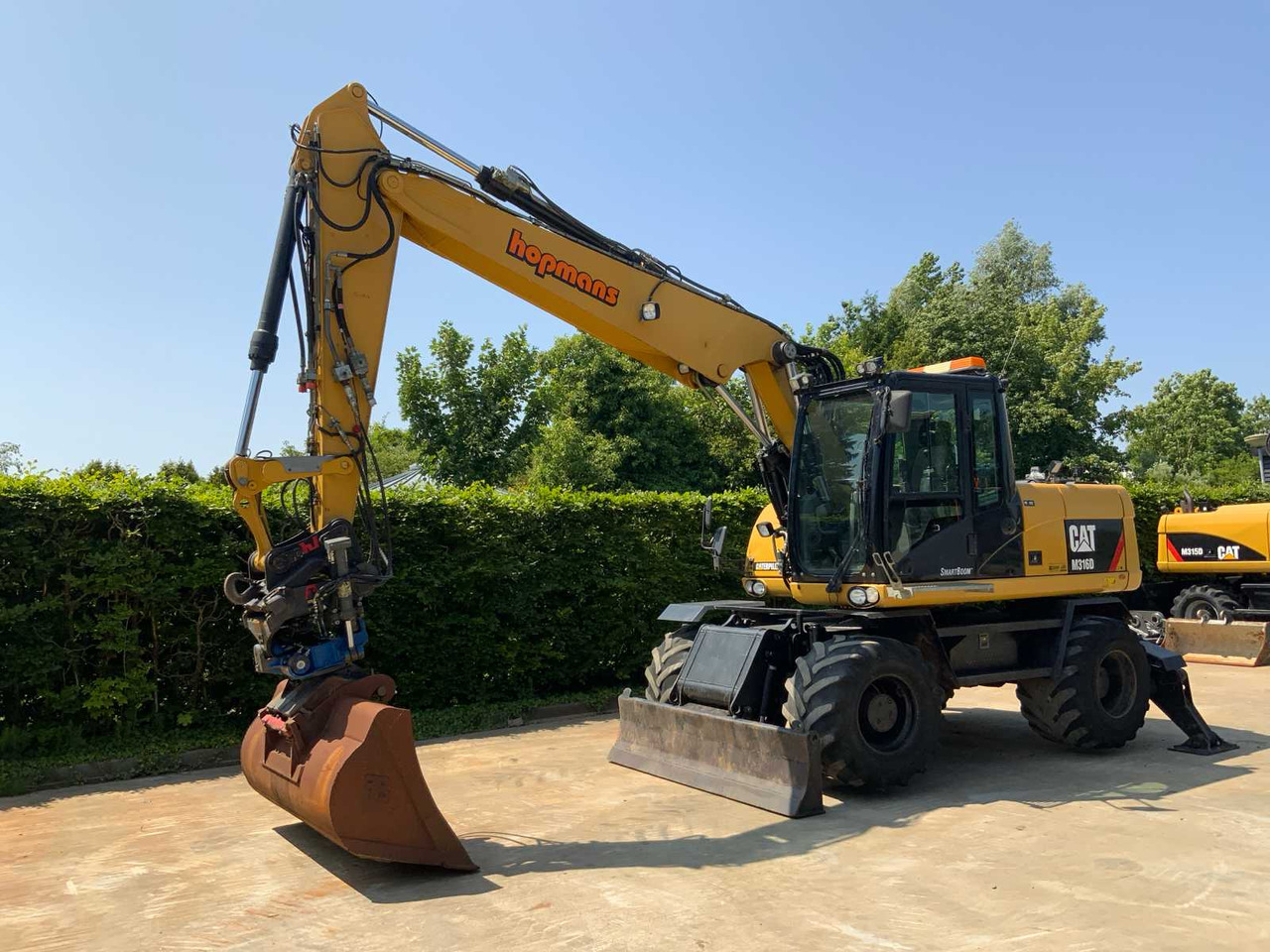 Caterpillar M316D - حفارة دولاب: صورة 1 Caterpillar M316D - حفارة دولاب: صورة 1
