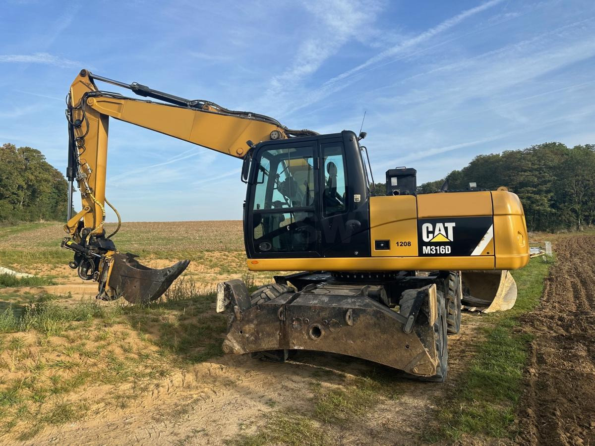 Caterpillar M 316D - حفارة دولاب: صورة 1 Caterpillar M 316D - حفارة دولاب: صورة 1