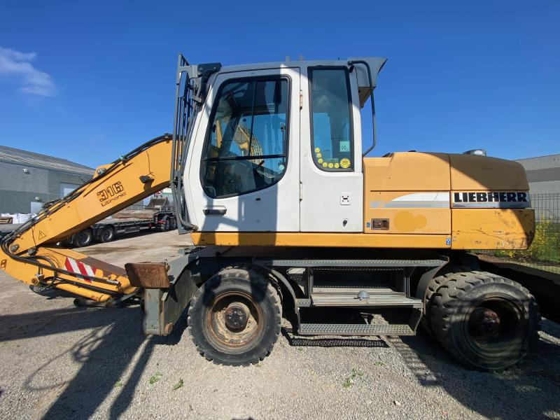 Liebherr A316Litronic - حفارة دولاب: صورة 1 Liebherr A316Litronic - حفارة دولاب: صورة 1